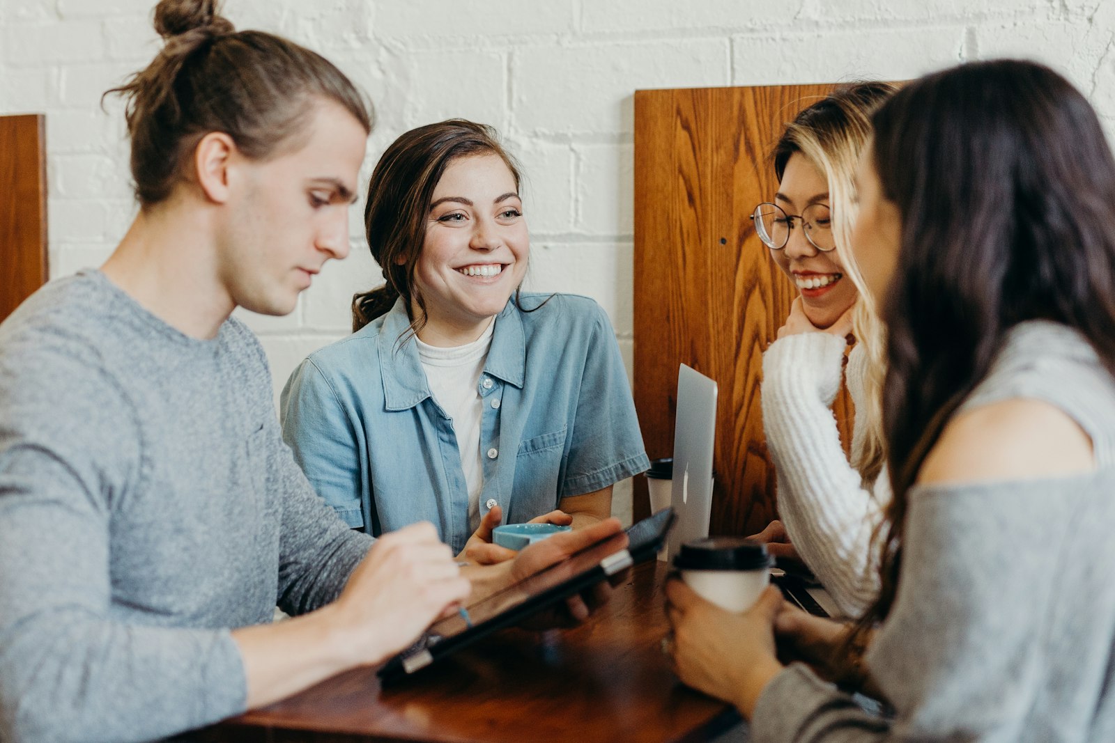A group of women friends laughing together over coffee